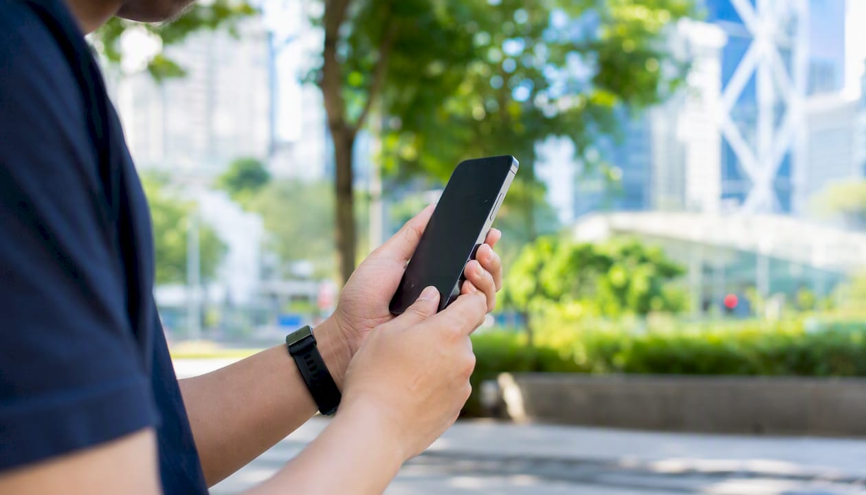 Hands inspecting refurbished smartphone