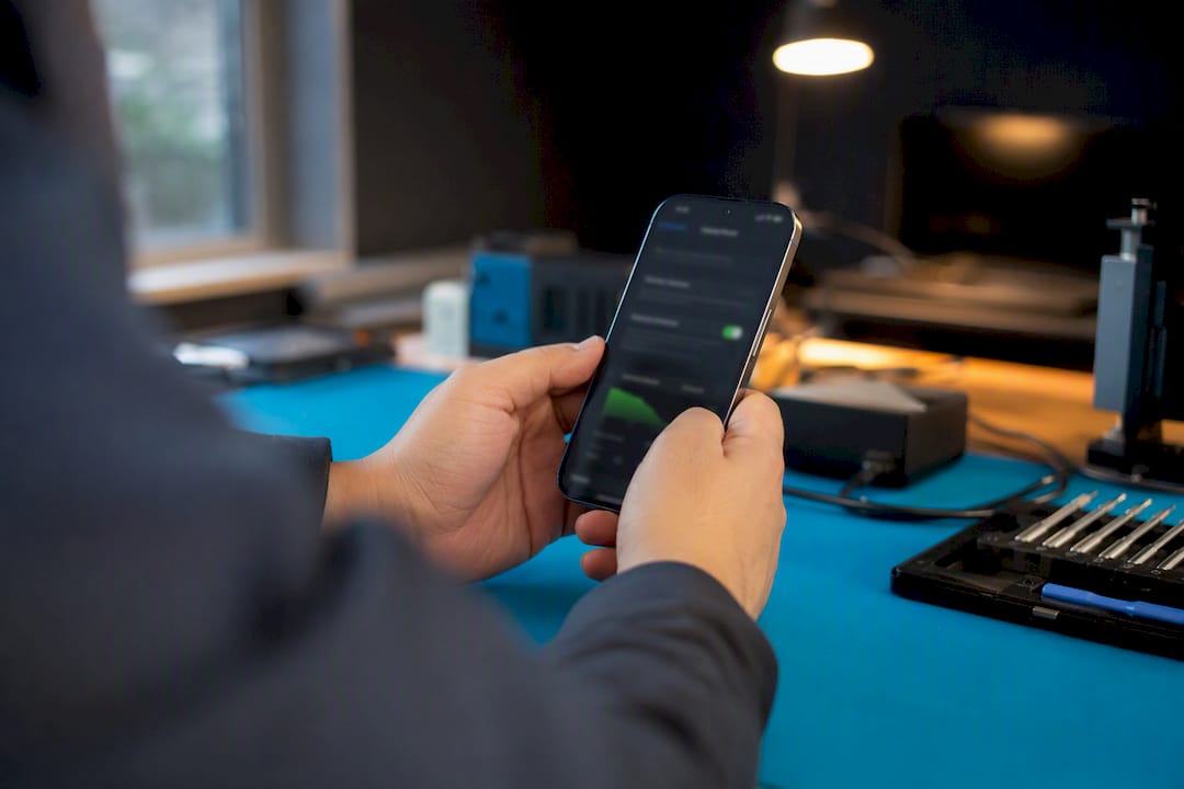Hands inspecting battery health screen on smartphone