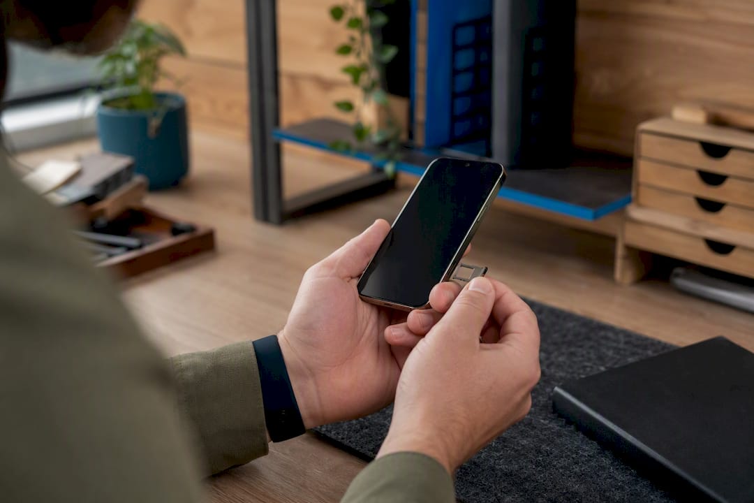 Hands holding smartphone partially showing edge