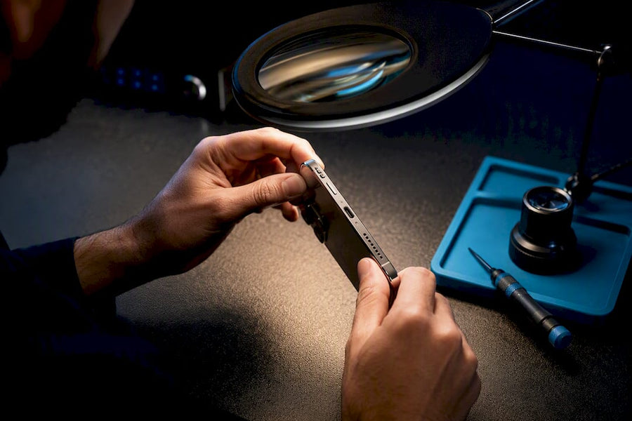 Technician inspecting refurbished phone components