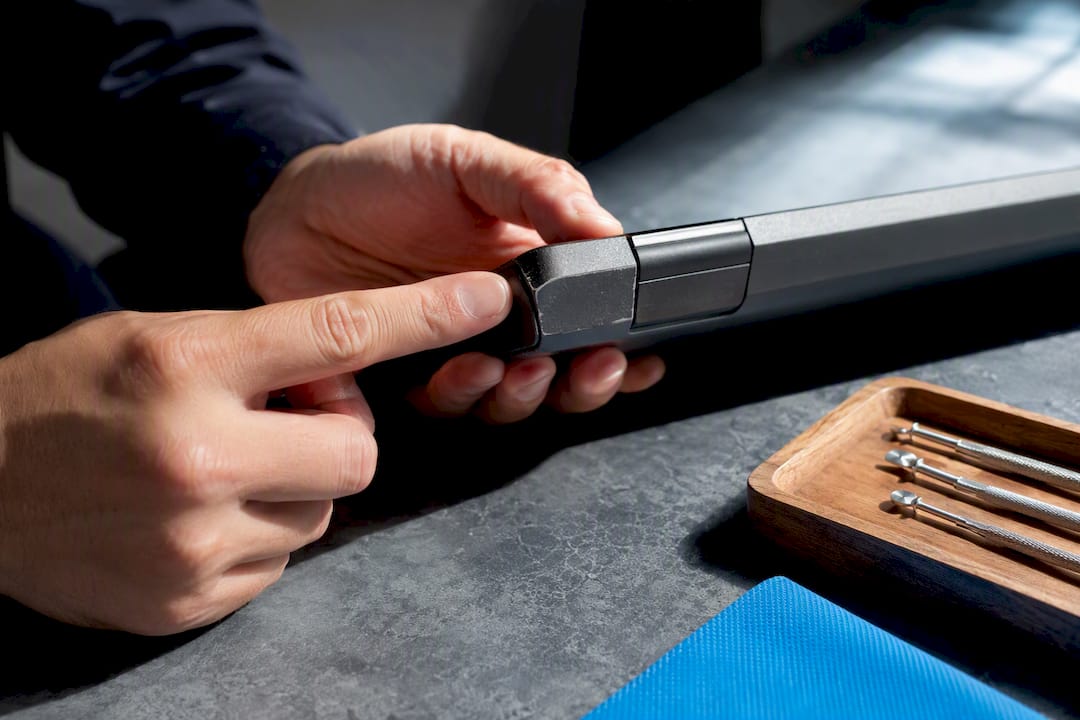 Technician inspecting refurbished laptop condition