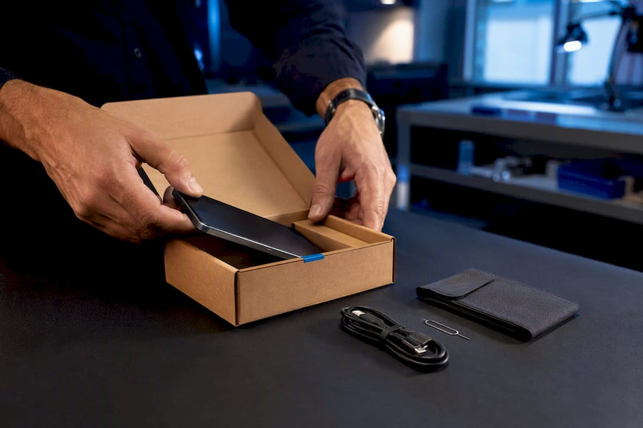 Buyer inspecting refurbished phone package
