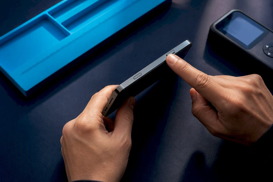 Technician verifying refurbished phone components