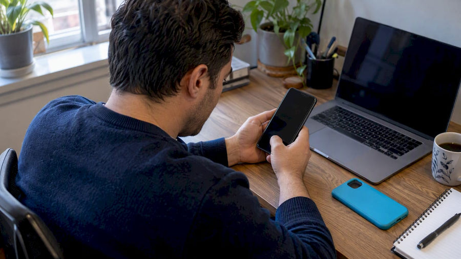 Shopper checking a refurbished phone's IMEI